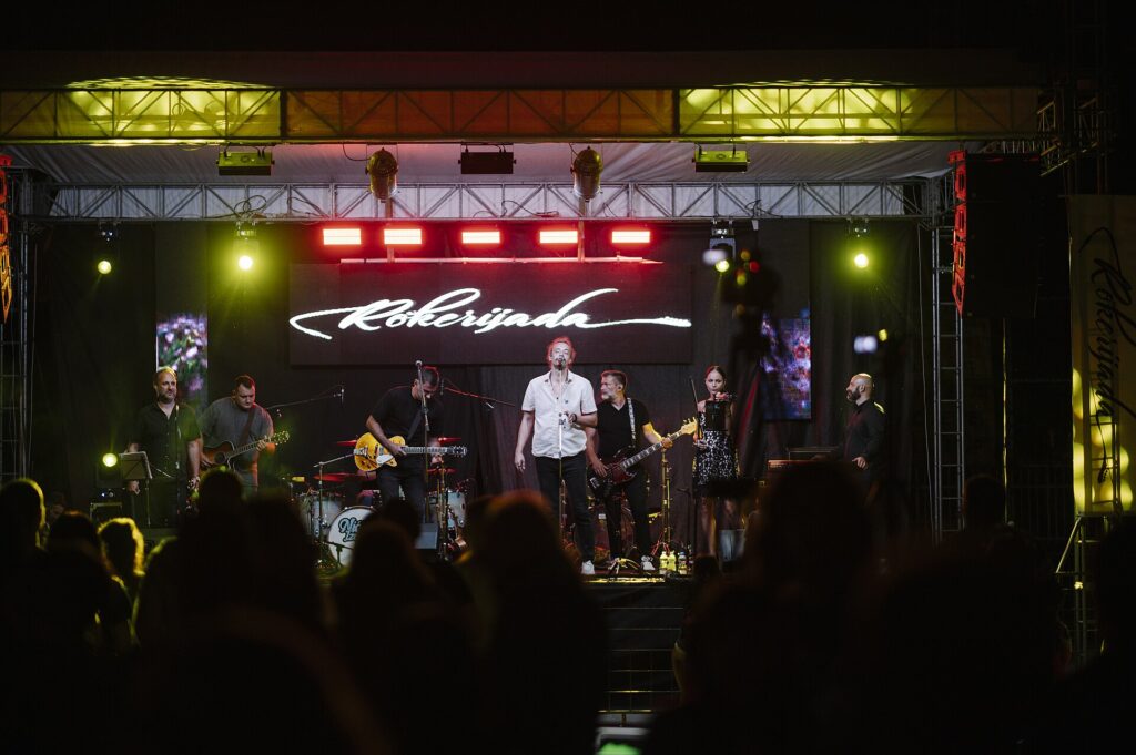 Crowd at a music festival main stage with bright lights at night