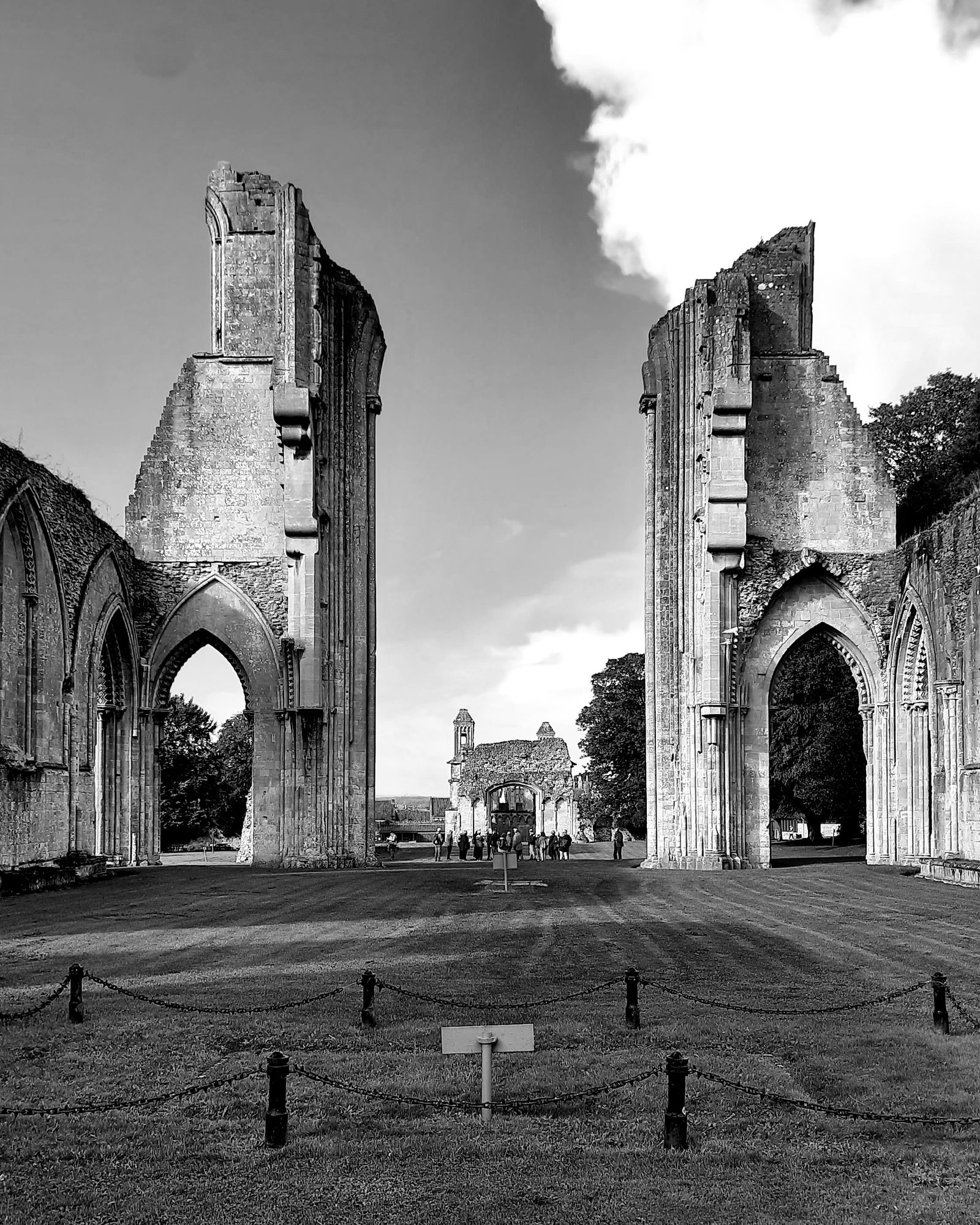 Black and white view of the stone arches and ruins of Glastonbury Abbey
